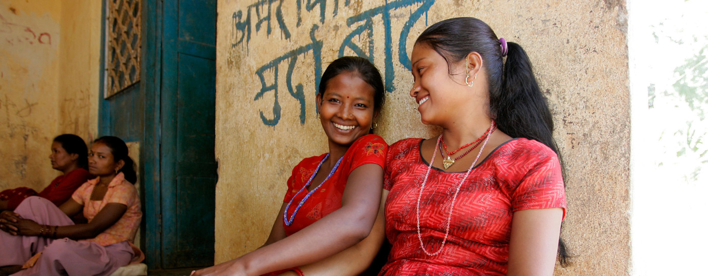 women-sitting-against-wall