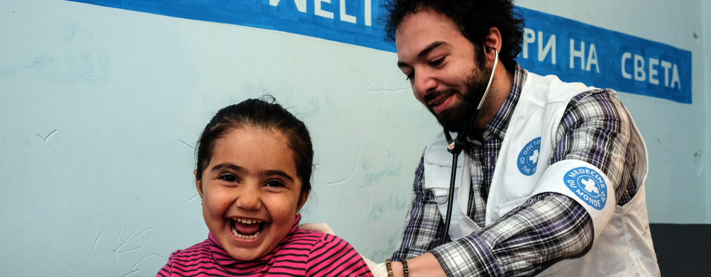 medic-helping-laughing-girl-patient